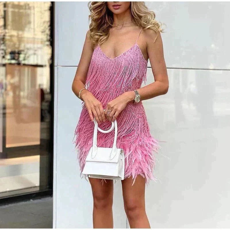 Maelys Fombelle pink fringe mini dress with tiered tassel strands, a feather trimmed hem and deep V neckline